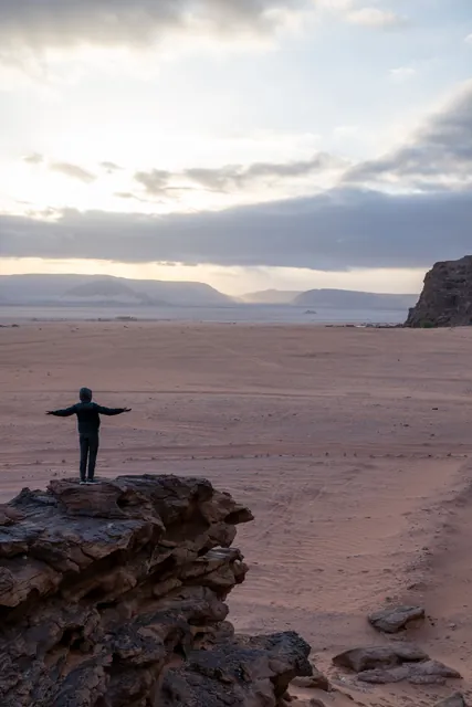 Silhouette on a desert rock at dusk